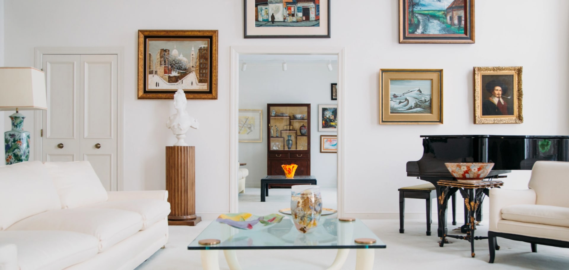 A luxury art and antique filled living room for an estate sale project by brown button