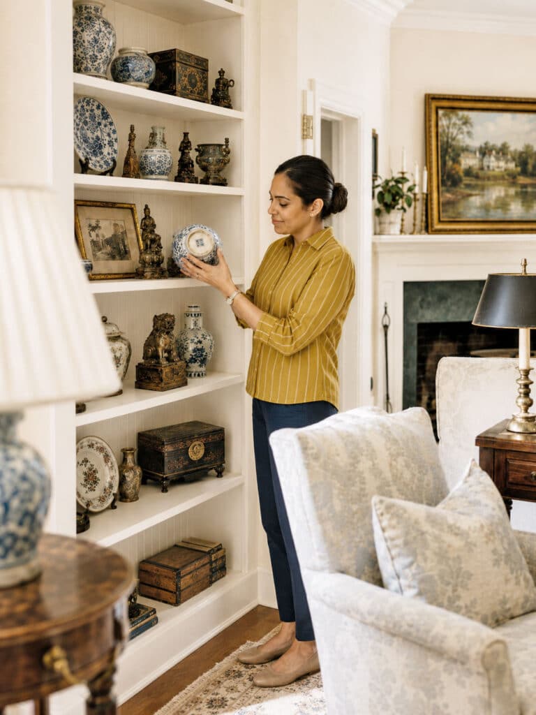 estate sale staff reviewing an antique item for sale